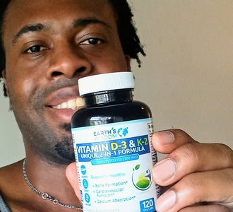 man holding a bottle of earth's wisdom vitamin d3 and k2 formula