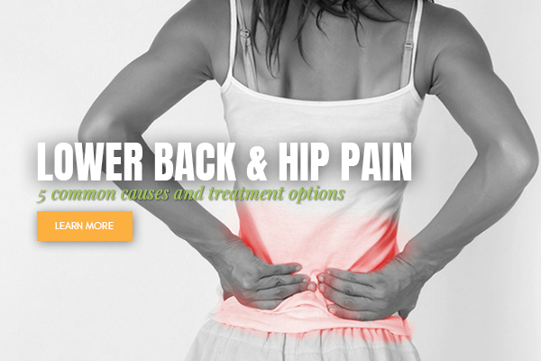 woman holding her lower back 