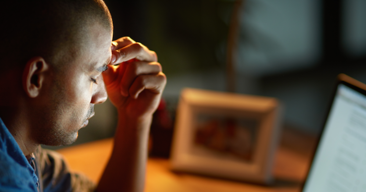 man having a headache due to chronic illness