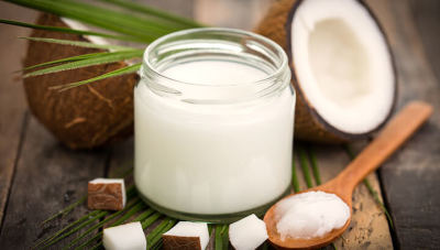 coconut oil in a jar on a spoon