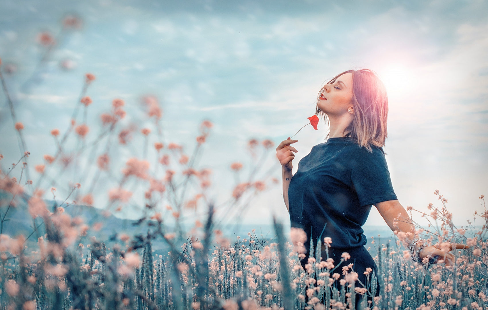woman in a field full of flowers enjoying the nature without effects of stress on the body