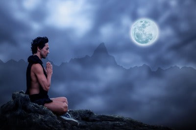 man meditating at night manage stress